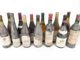 several bottles of wine are lined up on a white surface
