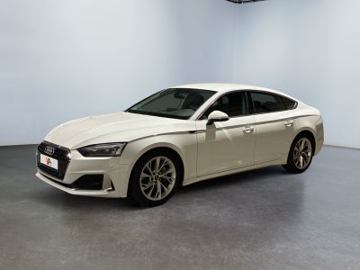 the white audi sedan is parked in a large room