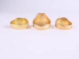 three gold rings on a white background
