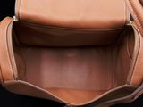 the inside of a brown purse with a zipper open