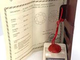 a red wax seal sitting on top of a brown case