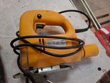 a yellow corded machine that is on the floor
