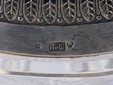 a close up of a silver plate with a clock on it