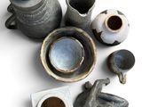 many different types of pottery on a white surface