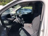 the interior of a car with the door open and the driver ' s seat down