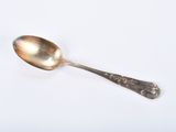 a spoon that is sitting on a white surface