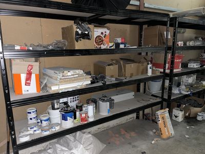a room with a lot of boxes and supplies on the shelves