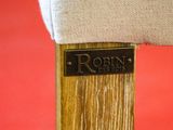 a close up of a wooden chair with a name plate on it
