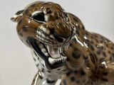 a figurine of a leopard that is sitting on a table