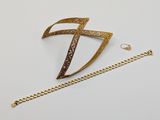 a close up of a necklace and a chain on a white surface