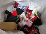 a bag full of items sitting on a bed