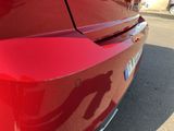 a close up of a red car ' s rear end
