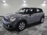 the mini countryman is parked in the garage on a checkered floor