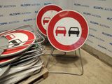 two red and white road signs on a metal stand