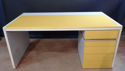 a yellow and white desk with three drawers