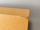 close up of a cardboard box on a table with a white background