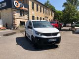 a white van parked in a parking lot in front of a building