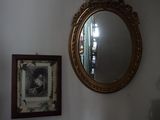 un miroir accroché au mur au-dessus d'une commode dans une pièce
