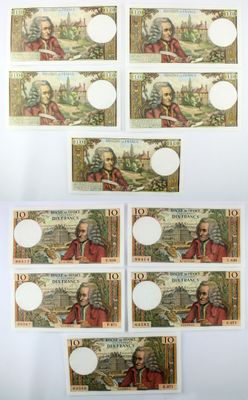 a group of five different bills with a picture of a man and a woman on them