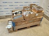 several boxes of assorted metal parts are stacked on a pallet