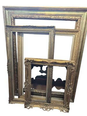 an image of a gold picture frame sitting on top of a white wall