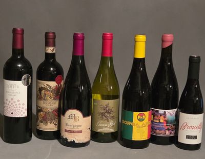several bottles of wine are lined up in a row on a table