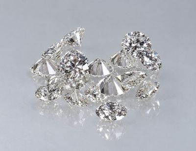 a close up of a bunch of diamonds on a white surface