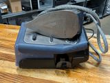 a small machine that is sitting on a wooden table