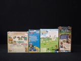 three boxes of games on a black surface