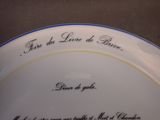 a white plate with a blue border and writing on it