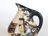 a vase with a painting of a man sitting on a bench