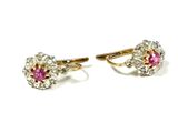 a pair of pink sapphire and diamond earrings on a white background