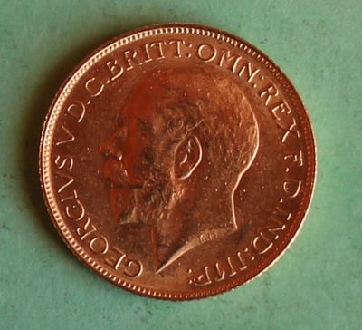 a close up of a coin on a table with a green background