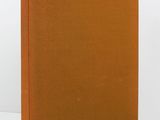 an orange book sitting on top of a white table