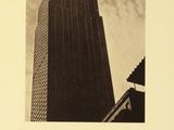 an old photo of a tall building with a sky background