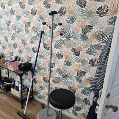 an image of a room with a wallpapered wall and a stool