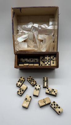 an open box of dominos sitting on top of a table