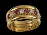 a close up of a gold ring with pink and white stones