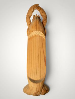 an image of a wooden statue of a woman holding a baby