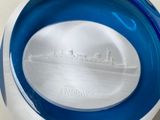 a blue and white bowl with a picture of a ship on it