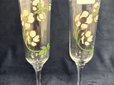 pair of hand painted champagne flutes with flowers on them