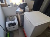 a white refrigerator sitting in a kitchen next to a window