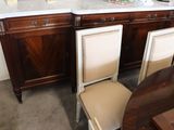 four chairs sitting next to a table with a marble top