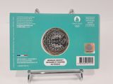 the back of a green card with a picture of a coin on it