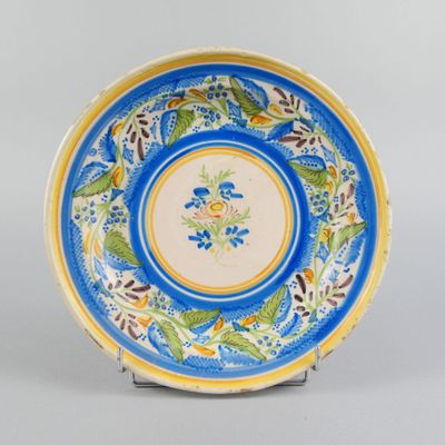 an image of a blue and yellow plate with flowers on it