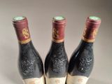 three bottles of wine sitting next to each other on a table