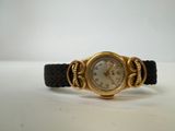 an image of a gold wrist watch with a black band