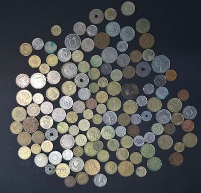 a lot of coins that are on a black surface