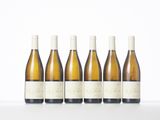 six bottles of wine lined up in a row on a table
