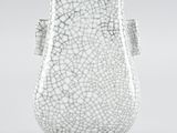 a close up of a white vase with a cracky surface
